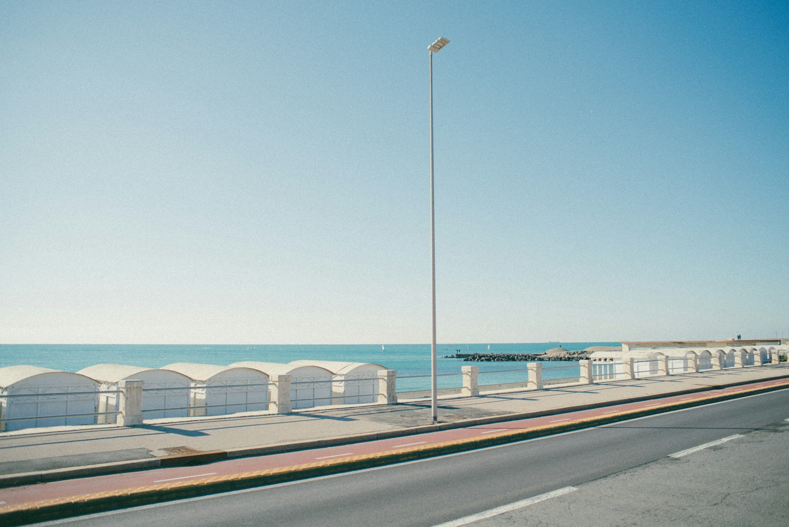 A view of the ocean from the side of a road
