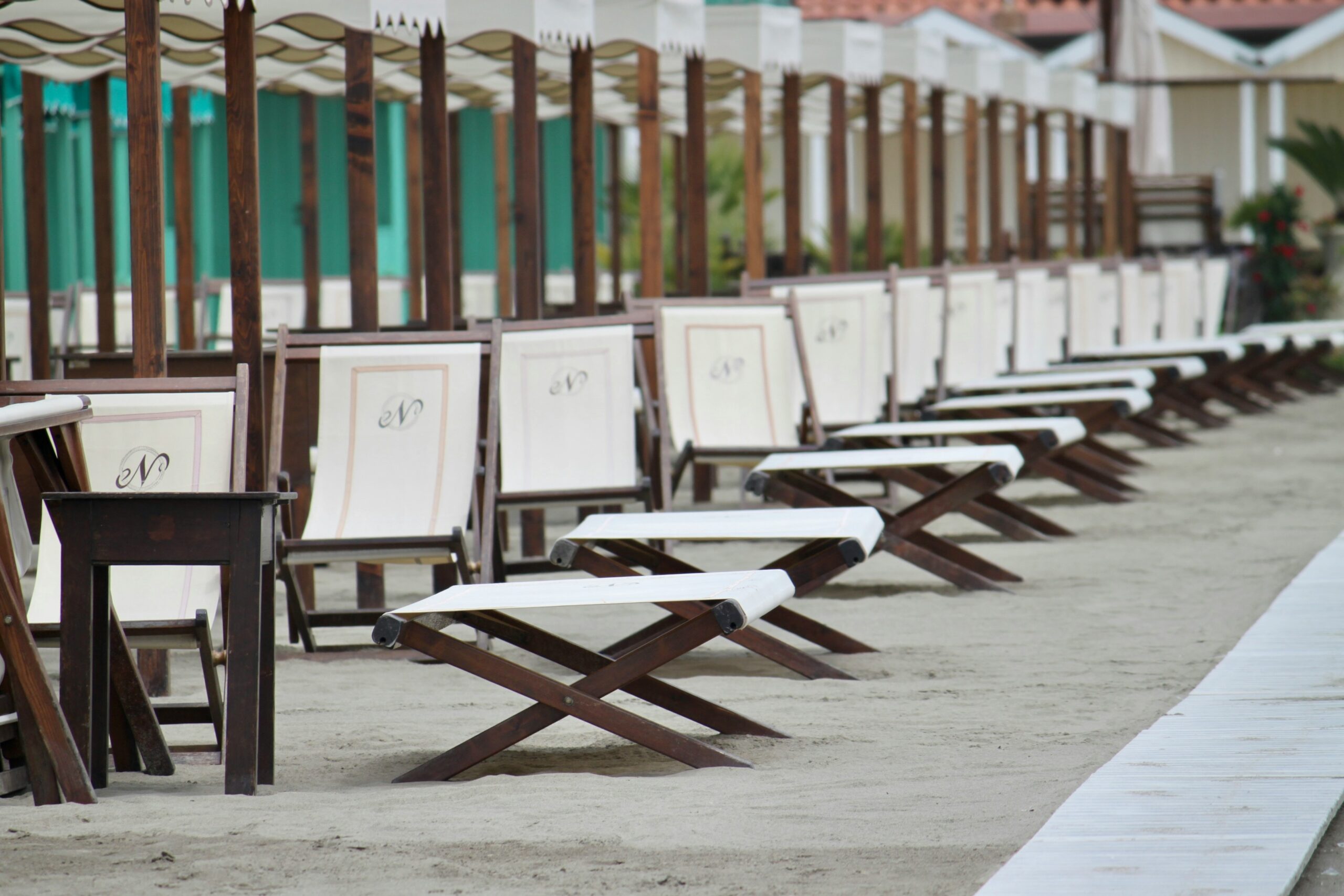 brown wooden folding chairs on gray concrete floor during daytime