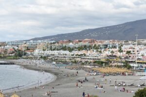 Relaxing beach scene at Playa de Fañabé in Costa Adeje, Tenerife, showcasing vibrant coastal life.