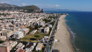 Aerial view of Latina city and beach in Lazio, Italy. Clear blue sky and coastline.