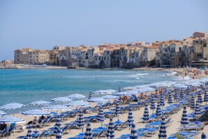 Beach with umbrellas and buildings along the coast