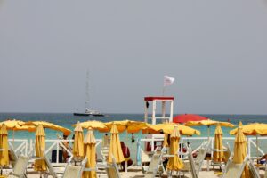 white and red beach umbrellas on beach during daytime