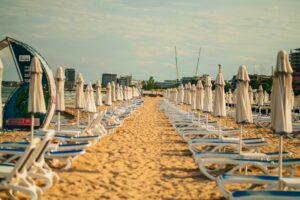 A row of beach chairs sitting on top of a sandy beach